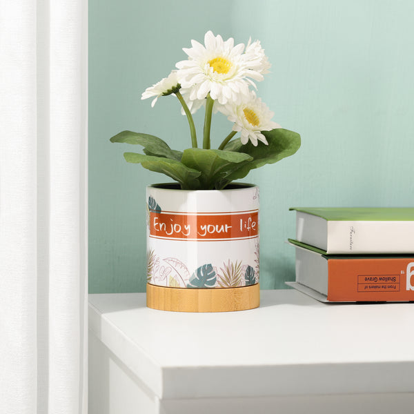 Decorated sublimation flower pot with bamboo base holding white daisies, placed on a desk for stylish home garden display.