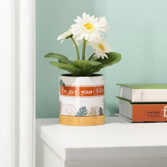 Decorated sublimation flower pot with bamboo base holding white daisies, placed on a desk for stylish home garden display.