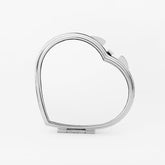 A silver heart-shaped compact pocket mirror with a clasp closure, displayed against a white background.