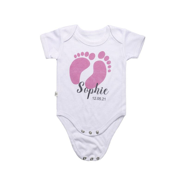 White sublimation baby bodysuit with pink baby footprints and custom text for laser engraving
