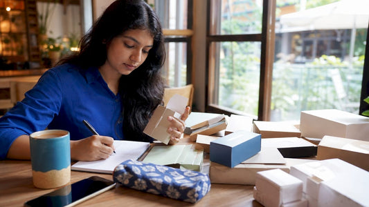 Woman comparing small business packaging options
