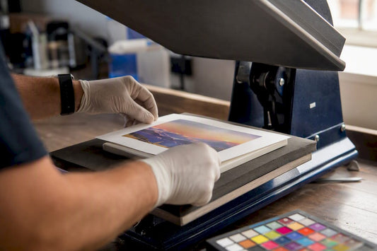 Hands positioning sublimation transfer on blank at heat press