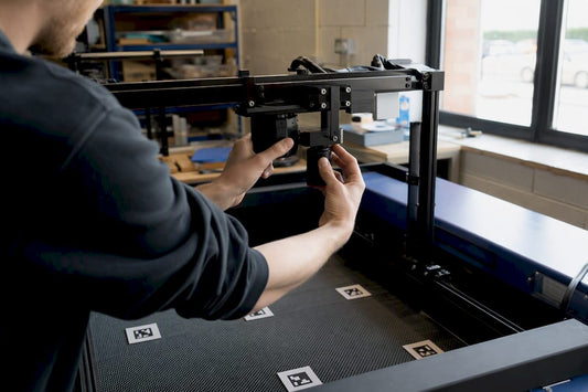 Hands adjusting laser engraving camera mount