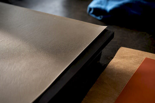Protective sheets arranged on heat press platen