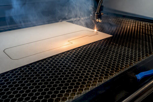 Laser cutting sheet above honeycomb bed