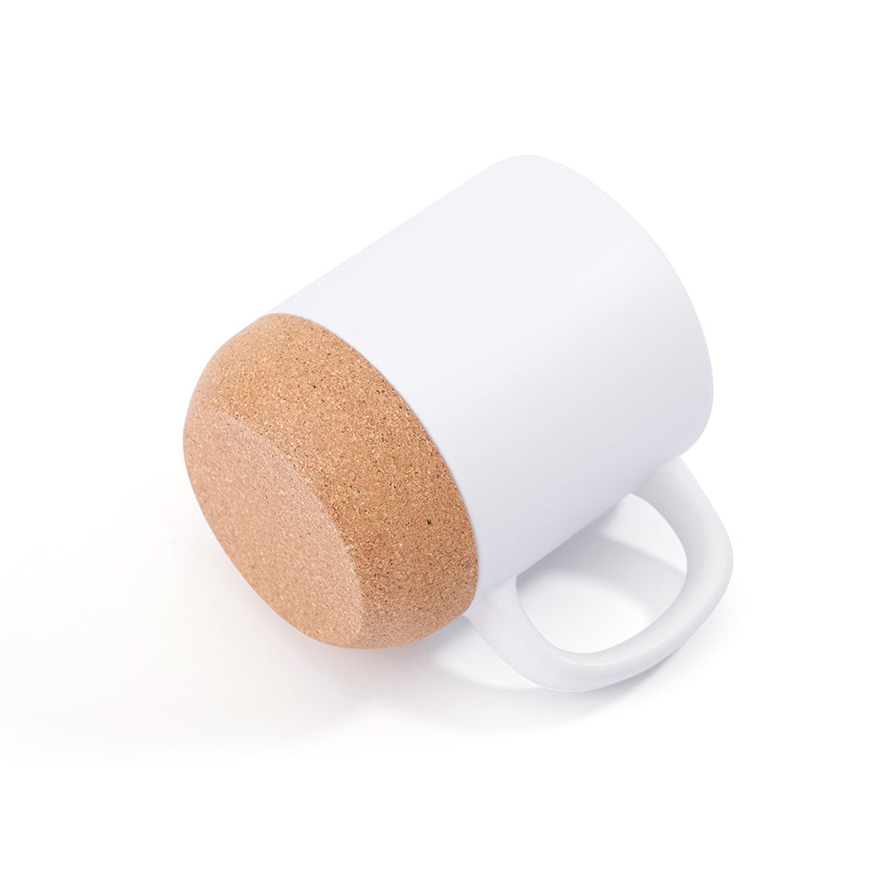 Bottom view of 13oz sublimation mug featuring smooth matte white body and eco-friendly cork base, ideal for custom drinkware projects.