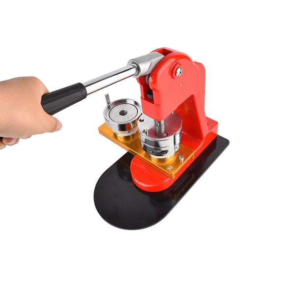 Manual red 58mm badge machine in use, featuring a rotating mold base and ergonomic handle for easy custom badge making in craft projects.